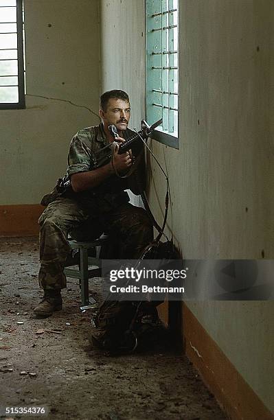 Saigon, Vietnam: Photo shows SFC Harman Strader, Alton, Illinois, watching through the window of the third floor of a Vietnamese house. He watches...