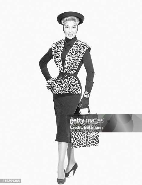 Hollywood, CA- Actress Dolores Gray wears a black wool jersey sheath dress topped with peplumed vest in leopard. The black silk jersey scarf extends...