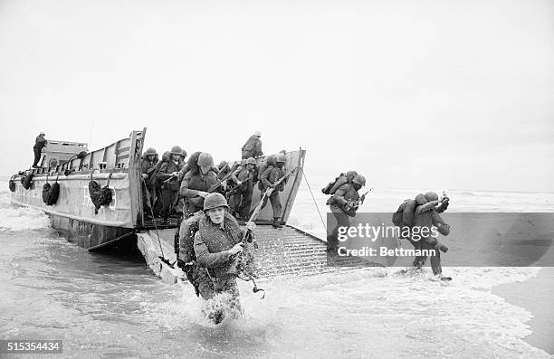 Da Nang, South Vietnam- US marines splash ashore from a landing vesel at a beach some ten miles north of Da Nang early March 8th. The Leathernecks...