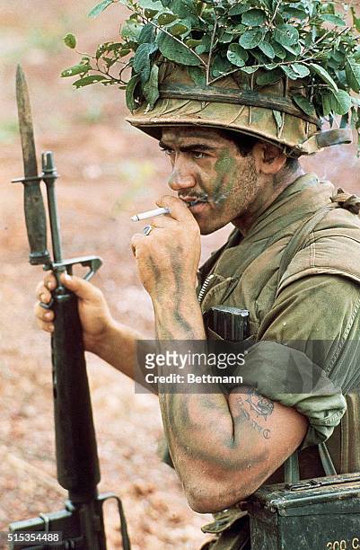 Saigon, Vietnam- ORIGINAL CAPTION READS: A wounded soldier from the U.S. 9th Infantry Division troops receives field aid at the edge of Y bridge...