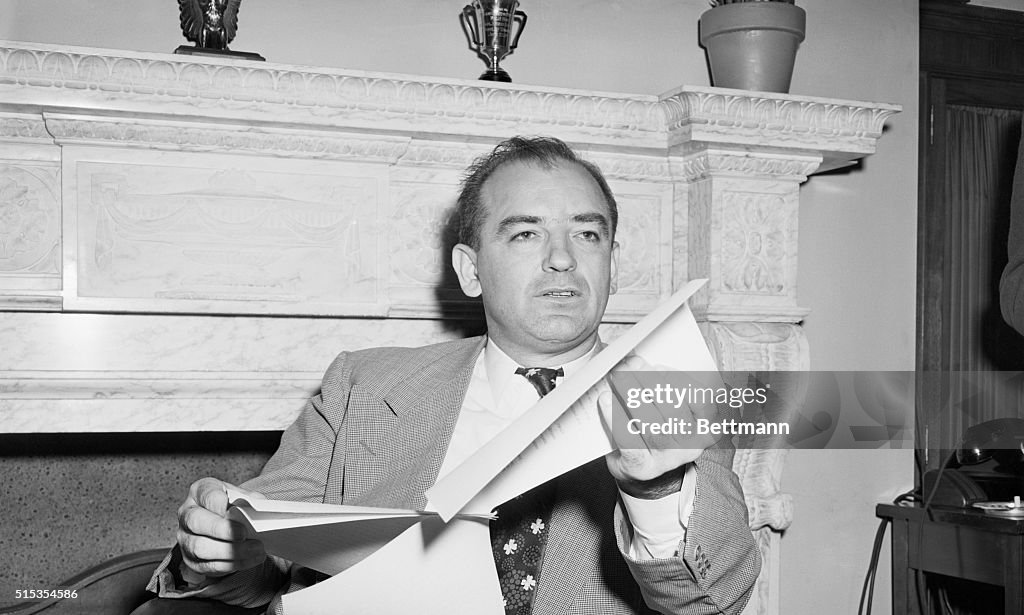 Joseph McCarthy Seated Holding Papers