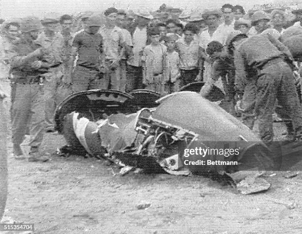 Havana, Cuba- Cubans stand looking at part of the wreckage of a plane alleged to be the US Air Force U-2 plane in which Air Force Major Rudolph...