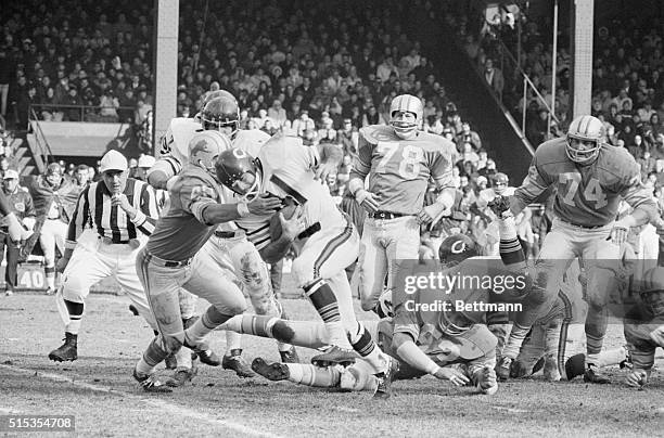 Detroit, MI- Bear halfback Brian Piccolo manages 9 yards running over right tackle before being stopped by Lion Tom Vaughn , during the first half of...