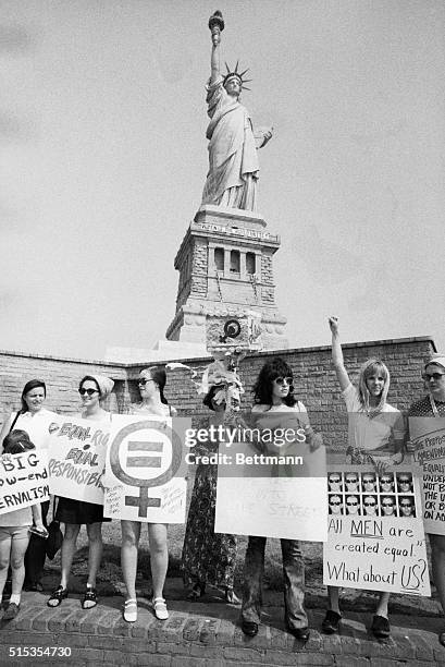 Group of women rally at the Statue of Liberty in support of the recent passage of the Equal Rights Amendment by the United States House of...