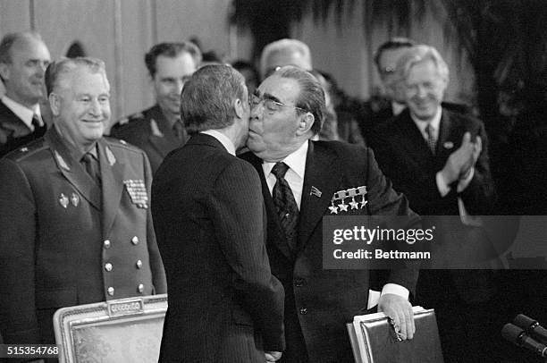 Vienna, Austria- Soviet President Leonid Brezhnev, holding the signed copy of the SALT II Treaty, plants a kiss on the cheek of President Jimmy...