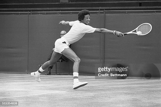 American tennis player Arthur Ashe grimaces as he hits a backhand return to American Jimmy Connors during their 7/5 men's singles title match at...