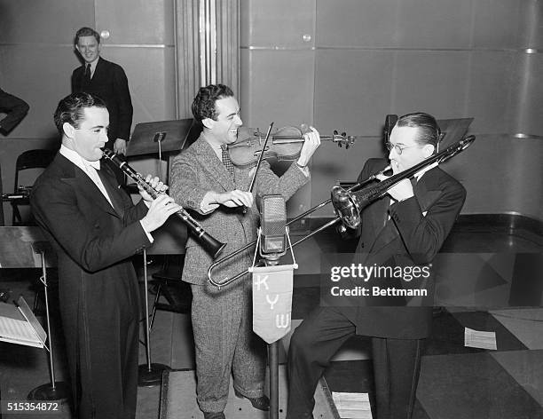 Philadelphia, PA- Noted orchestra leaders Buddy Rogers; Jan Savitt of KYW; and Tommy Dorsey are pictured as putting on an impromtu "swing" show for...