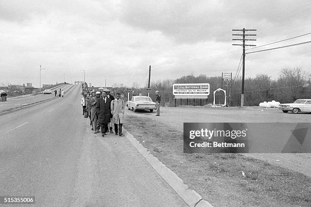Selma, AL- Long line of Negro marchers, led by SNCC representative John Lewis and Rev. Hosea Williams, leaves bridge across Alabama River past...