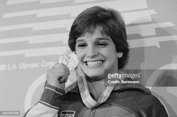 American Olympic gymnast Mary Lou Retton holds up her gold medal at a press conference during the 1984 Summer Games in Los Angeles. Mary Lou, who has...
