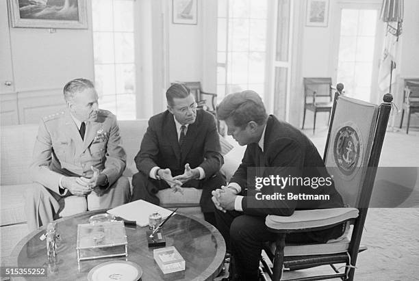 President John F. Kennedy speaks with his advisors, Gen. Maxwell Taylor, Chairman of the Joint Chiefs of Staff , and Defense Secretary Robert...