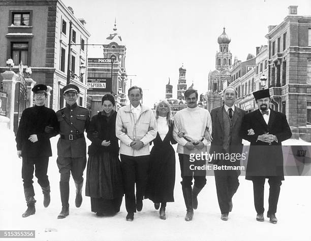 Madrid, Spain- The stars of MGM's new film, "Dr. Zhivago" link arms as they stroll down a "street" on one of the sets being used in the movie. Left...