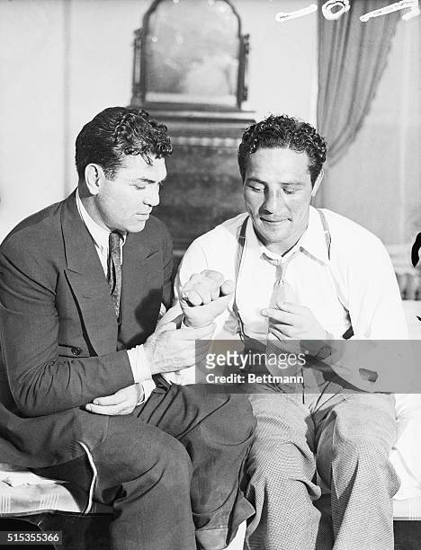 New York, NY- Max Baer, new fistic sensation, shows to Jack Dempsey the right hand that brought him victory in the tenth round of his scheduled...