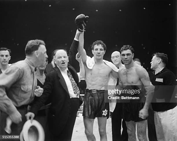 Announcer Joe Humphries declares boxer Max Baer the winner after the tenth round of his match with Max Schmeling.