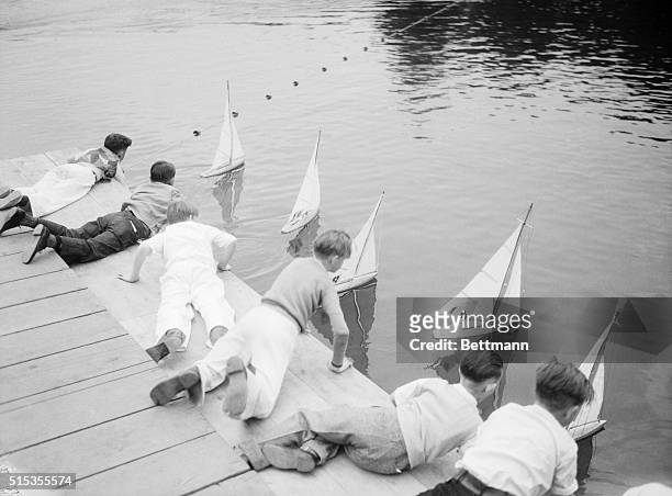 Los Angeles, CA- A crowd of boys and some girls, too, today proudly carried their miniature yachts down to the lake in Echo Park and sailed them in...