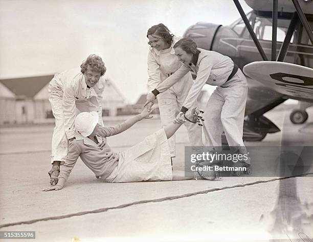 Roosevelt Field, LI, NY- The other three skating contestants aid Mrs. Betty H. Gillies to her feet, after she had "crahsed" during practice roller...