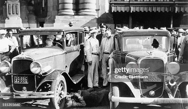 Kansas City, MO- Scene in front of the Kansas City railroad depot, showing two bodies of the four slain officers lying between two bullet-riddled...