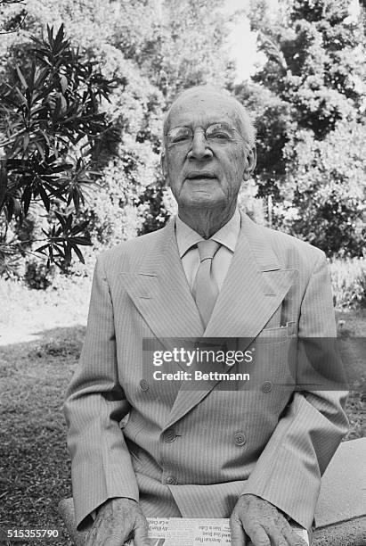 Picture shows writer and Socialist activist, Upton Sinclair, seated with his hands in his lap wearing a suit.