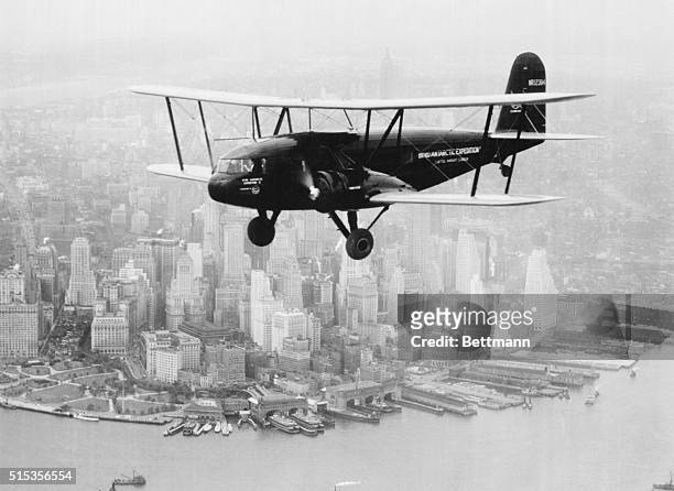 New York, New York: Admiral Byrd's flight to the South Pole, 1933. Passing the tip of Manhattan with the airplane, The America, a Curtiss Condor.