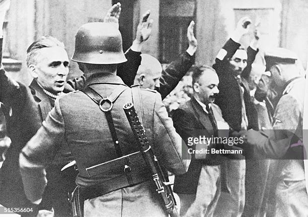 Nazi troops arrest civilians in Warsaw, Poland, 1943.