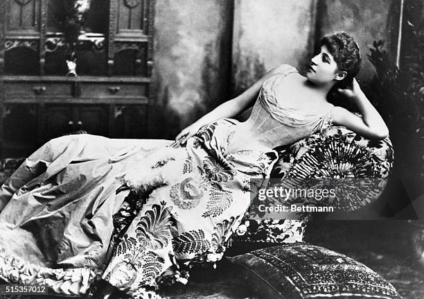 Lily Langtry, the English beauty and actress reclining on a sofa.