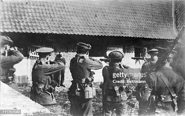 Firing squad composed of British soldiers, during World War I, aim their rifles at a German spy.