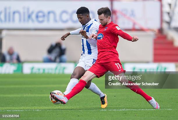 Boubacar Barry of Karlsruher SC challenges Denis Thomalla of 1. FC Heidenheimduring the second bundesliga match between Karlsruher SC and 1. FC...