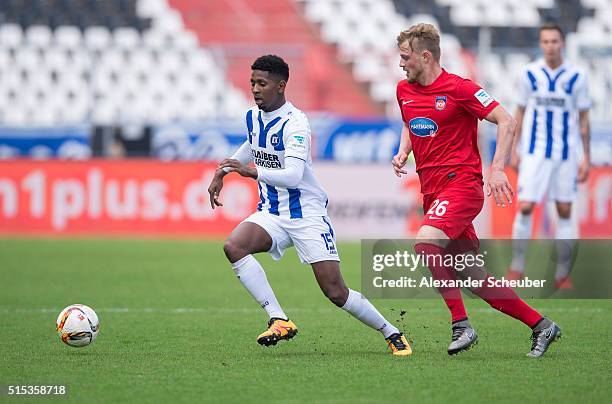 Boubacar Barry of Karlsruher SC challenges Marcel Titsch-Rivero of 1. FC Heidenheim during the second bundesliga match between Karlsruher SC and 1....