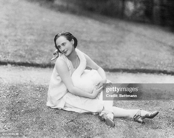 Anna Pavlova , Russian ballet dancer, shown with one of her pet swans, wrapped around her, which inspired her famous dance "Death of the Swan."...