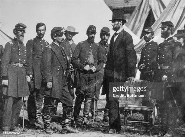 President Abraham Lincoln with General George B. McClellan at his headquarters at Antietam, October 3, 1862. From left: General George W. Morell,...