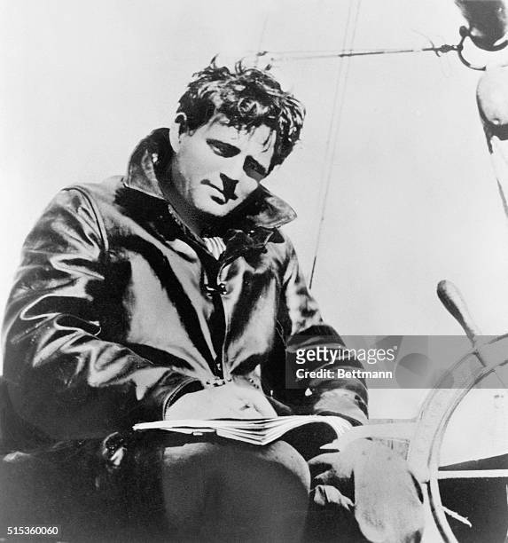 Jack London , American novelist and short-story-writer writing aboard ship. Undated photograph.