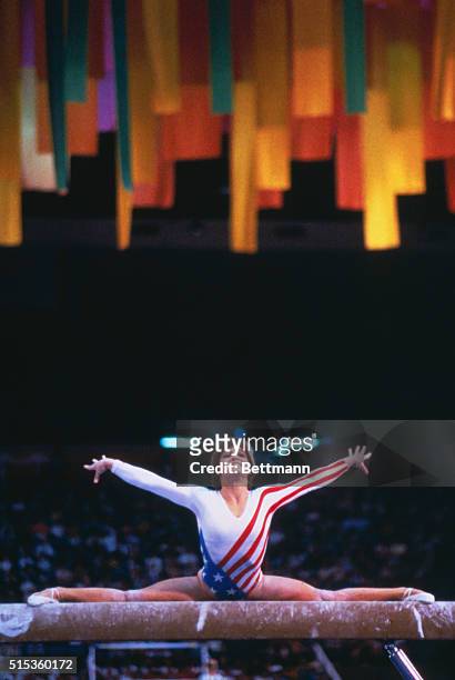 Mary Lou Retton performs on the balance beam on her way to becoming the first American woman to win the women's gymnastics individual all-around...