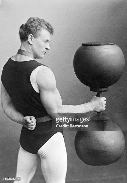 Eugen Sandow, the strong man, in weight-lifting act, circa 1895.