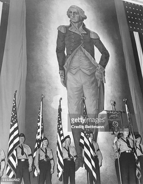 American Flags, Swastika and Washington. New York: A color guard holding American Flags and a banner, inscribed with the Nazi Swastika stands before...