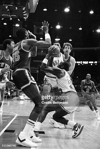 Bulls' Michael Jordan ducks before going up for a shot in front of Louis Orr of the New York Knicks in the first half at Chicago Stadium 1/11. In...
