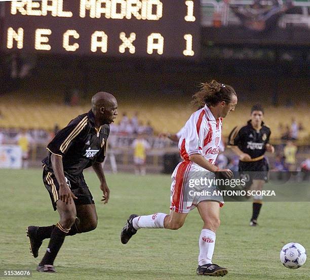 Necaxa's Alex Aguinaga takes the ball from Real Madrid's Gerem 14 January during the third place final in the World Club Championship at Maracana...