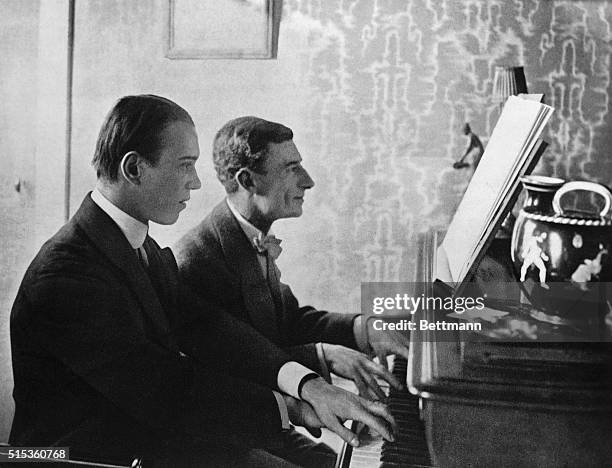 Choreographer Vaslav Nijinsky and composer Maurice Ravel at the piano playing a score from Daphnis and Chloe.