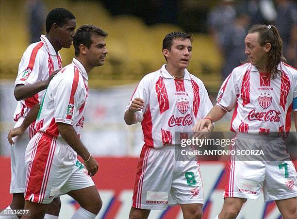 Necaxa's Alex Aguinaga celebrates with teammates Luis Perez and Sergio Almaguer the goal scored by Delgado 14 January during the third place final in...