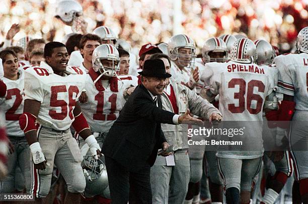 Dallas: A very happy Ohio State coach Earle Bruce welcomes some of his players approaching the sidelines near the end of the Buckeyes 28-12 Cotton...