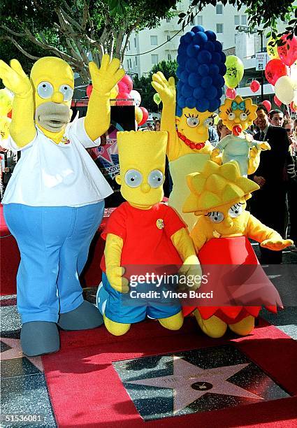 Characters from "The Simpsons" Homer, Bart, Lisa, Marge and baby Maggie stand next to the star they received 14 January 2000 on the famous Hollywood...