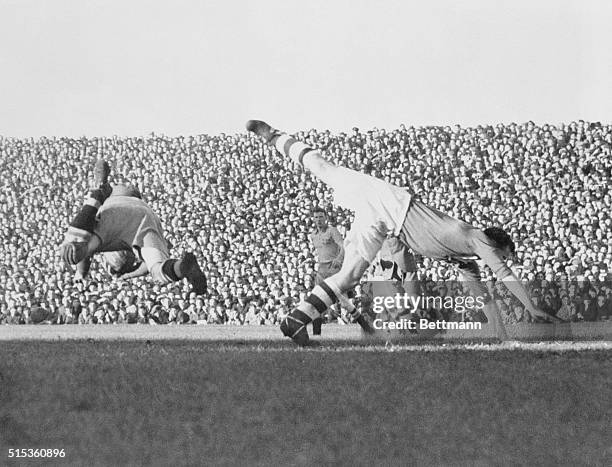 Ireland's center forward, D. Walsh, plunges forward as T. Lindberg, Swedish goalkeeper, saves the ball in the second match between the two teams in...