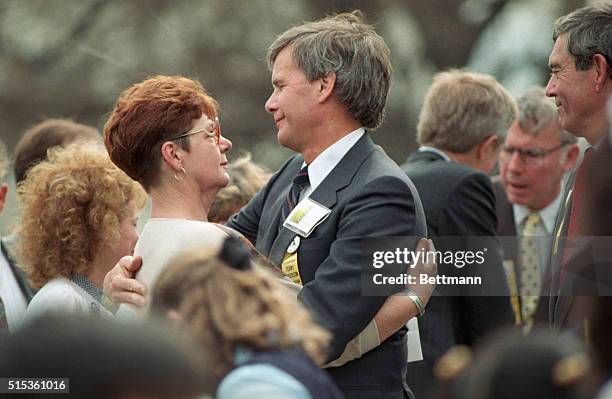 Peggy Say, sister of hostage Terry Anderson, is embraced by TV anchor Tom Brokaw at end of remembrance rally for hostages held in Lebanon.