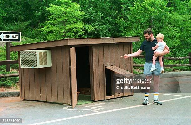 Fort Mill, S.C.: Former PTL employees Paul Marrin and his son, Matthew look over Jim and Tammy Bakker's air-conditioned doghouse that has been moved...