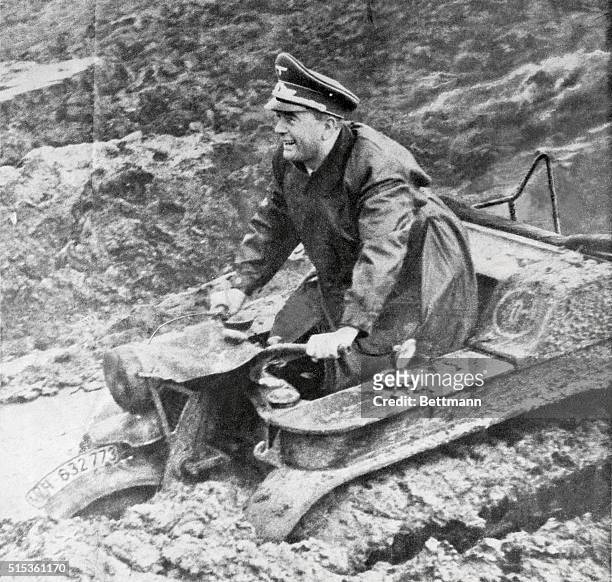 Albert Speer, Nazi Minister for Armament and Munitions is the pleased looking test pilot of this new German "Tractorcycle" designed to make the Nazi...