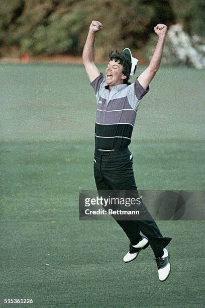 Augusta, GA- Larry Mize jumps high in the air after sinking a breathtaking 40-yard chip shot during second hole of sudden death to win the Masters...