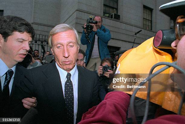 Members of the media surround corrupt financier Ivan Boesky and his attorney as they arrive at federal court in New York City, where he is to plead...