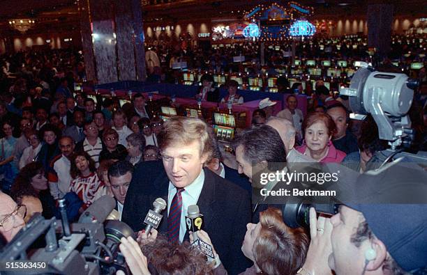 Atlantic City, N.J.: Billionaire developer Donald Trump discusses his new casino-the Taj Mahal- from in front of a sea of slot machines here. The...