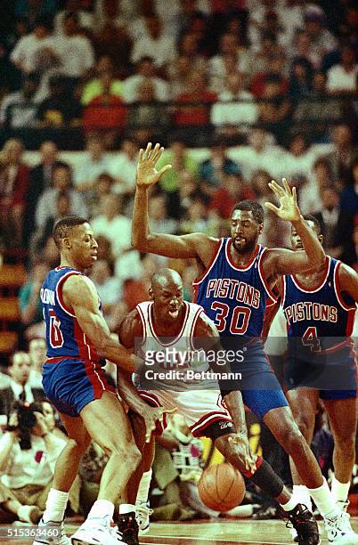 Pistons' Dennis Rodman; Tree Rollins and Joe Dumars surround Bulls' Michael Jordan during the 3rd quarter 5/21 of game two of the Eastern Conference...