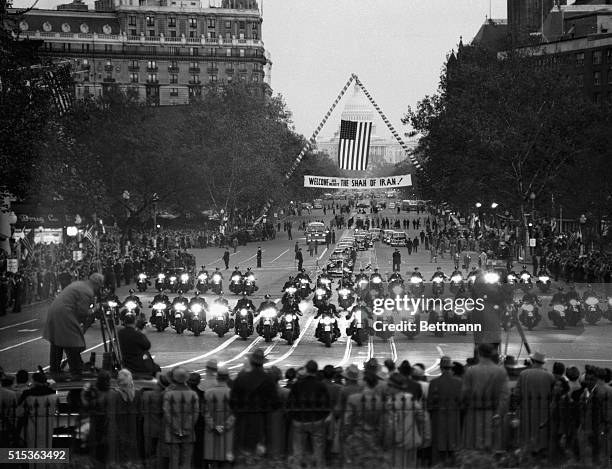 Riding with President Truman, the Shah of Iran, on a month-long goodwill visit to the U.S., is escorted at dusk by motorcade from National Airport,...