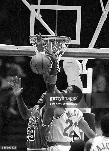 Chicago Bulls Michael Jordan recovers the rebound from Houston Rockets Rodney McCray during the first period of play 3/16.