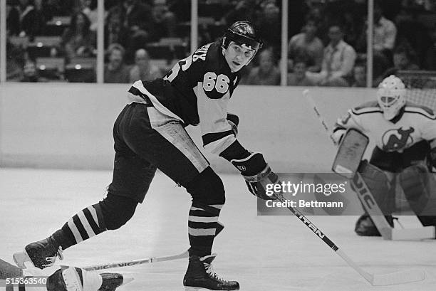 Mario Lemieux of the Pittsburgh Penguins skates in towards the goal as Ken Daneyko of the New Jersey Devils tries to break up the play during first...